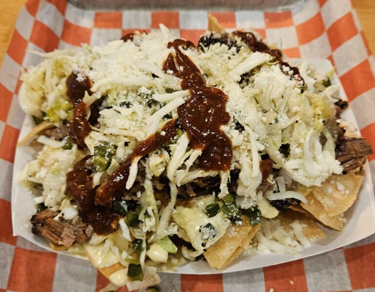 A crispy juicy brisket nachos covered with coleslaw, cheese, a splash of BBQ sauce. from Gordito's Rust Belt Tacos & Tortas. Gordito's restaurant is inside Fishers Test Kitchen in Indianapolis, Indiana.